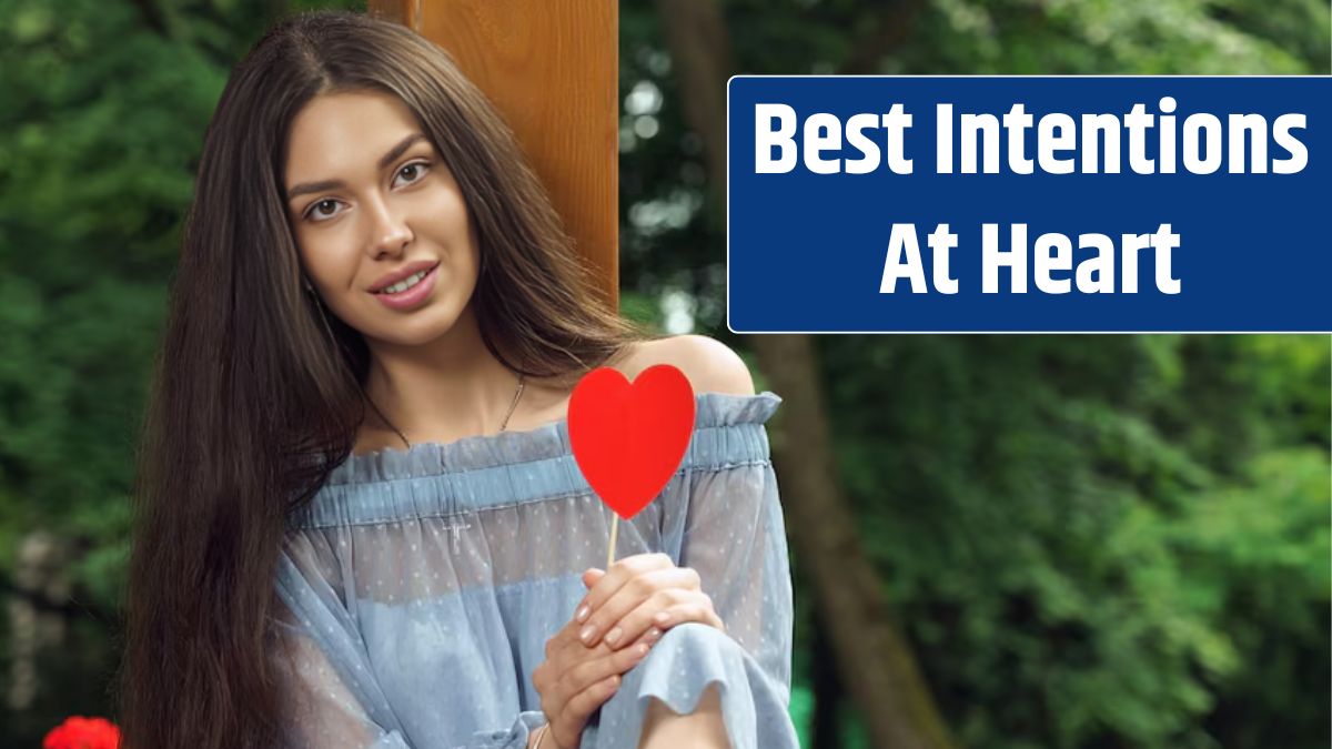 Pretty cheerful brunette woman holding a red heart.